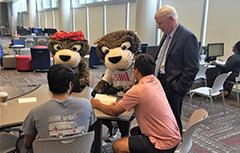 Dr. Waldrop, 南paw, and Miss Pawla with USA students at a table working